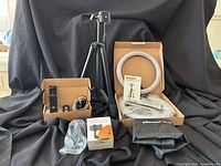 Full kit including ring light, tripod, suction cup phone holder packaging, and additional accessories