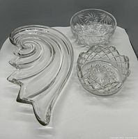 Photo showing all three items: the Mikasa glass shell dish and two clear crystal bowls with cut star patterns