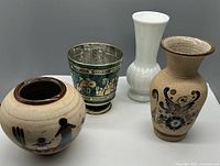 Four vases and planter arranged showing size and style differences