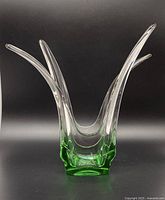 Front angle view of Tiffany Empress emerald green base vase with flared clear glass top against black background.