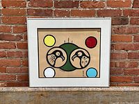 Full view of framed acrylic painting against brick wall