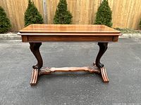 Full front view of the table on pavement with fence background