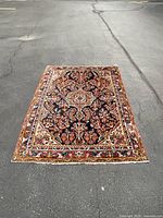 Full view of rug laid flat on pavement showing overall pattern and dimensions