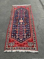 Full view of the rug laid on pavement showing overall pattern and dimensions