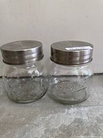 Front view of both Ball Mason jars showing logos and lids