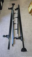Overall view of disassembled black metal king bed frame components