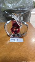 Front view of clear and red sommerso glass apple paperweight with leaf