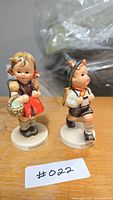 Front view of both Hummel figurines