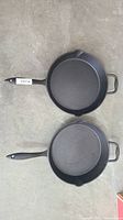 Top view of both Lagostina cast iron skillets showing interiors and handles