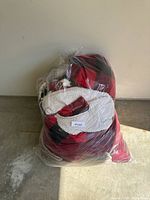 Bag of blankets front view showing plaid sherpa throw