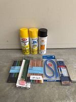 Overall view of spray cans and assorted pencil sets