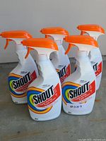 Five Shout Triple-Acting stain remover bottles standing on floor