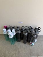 Group view of all 17 water bottles against wall