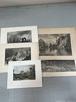 Five antique landscape prints arranged on a flat surface showing multiple castle and natural scenes in black and white and hand-colored styles.