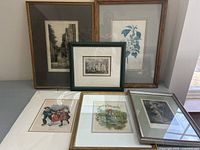 All six framed prints displayed together on a table showing variety of subjects and frame styles
