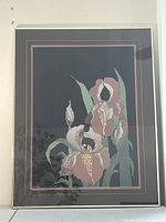 Full frontal view of framed signed print depicting irises on black background with double mat and thin gold frame.