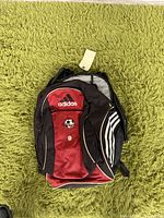 Front view of Adidas backpack showing red front panel with soccer logo, number 9, and Adidas branding