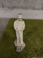 Front view of the golf figurine standing on the base.