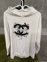 Front view of the white hoodie with black distressed graphic logo on the chest.
