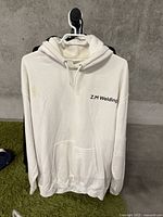 Front view of white size XL hoodie showing Z.M Welding logo on left chest, some minor staining visible on front.