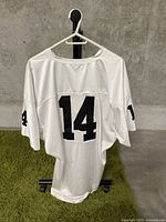 Back view of white football jersey showing black number 14 printed centrally on back and sleeves