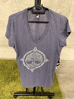 Front view of purple V-neck short sleeve t-shirt with white tree of life design.