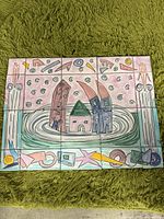 Front view of tile hanging showing colorful design of houses and abstract shapes on nine ceramic tiles.