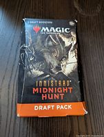 Front of the MTG Innistrad Midnight Hunt Draft Pack box showing werewolf artwork and branding.