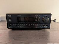 Front view of Onkyo TX-NR801 AV Receiver showing control buttons, volume knob, display screen, and headphone jack.