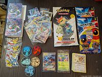 Full lot shown with all items visible including binders, keychains, cards, and packs