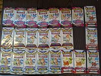 Overview of all 23 sealed Pokémon trading card fun packs arranged in five rows showing the various series and artwork on each pack.