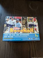 Sealed front view of the 2022 Topps Heritage Baseball Trading Card booster box showing player images and branding.