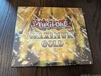 Sealed front view of Yu-Gi-Oh Maximum Gold Booster Box with branding and design details