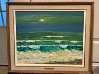Frontal photo showing the full framed oil painting of ocean waves at night with a yellow moon.