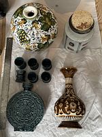 Top view of entire pottery collection showing vases, decanter, cups, and jar with cork