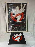 Full view of the Ghostbusters II Advance-B teaser movie poster in protective cover, with the smaller Ghostbusters logo print displayed below it on a white surface.