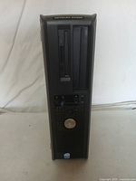 Front view of Dell OptiPlex 960 small form factor computer tower showing drive bays, USB ports, power button with Dell emblem.