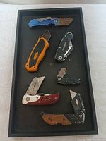 All six utility knives displayed in a black tray