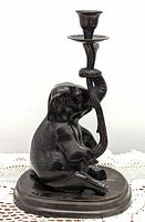 Front and side views of the Bombay elephant candlestick showing the carved stone elephant holding a metal candlestick branch