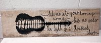 Front view of the clay tile showing artwork of a guitar and handwritten Ed Sheeran song lyrics.