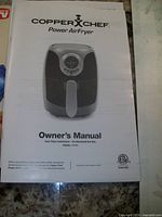 Owner's manual for Copper Chef Power Air Fryer model AF002 showing product image and safety instructions.
