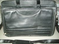 Front view of black full grain leather laptop case showing handles and front zippered pocket