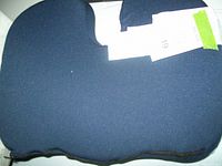 Dark blue ergonomic gel seat cushion with U-shaped cutout and fleece cover on one side, non-slip material on the other side