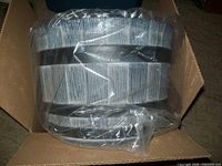 Photo of the whiskey barrel resin planter packed in a cardboard box with plastic wrap.