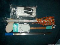 Photo showing all four senior health aids including shoe horn, foot brush, lotion dispenser, and sock pull.