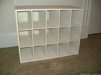 Front view of white shoe cabinet showing 15 cubed compartments in 3 rows x 5 columns, compact size for closet fitting.