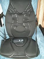 Full view of the black therapeutic electric chair pad resting on a blue padded chair, showing overall condition and design.