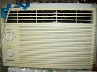 Beige Gold Star window air conditioner front view showing control knobs and grille vents.