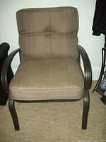 Assembled patio chair with black wrought iron frame and beige tweed cushions, showing full seat and backrest.