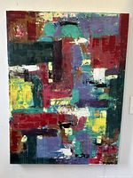 Frontal photo of large abstract oil painting showcasing vibrant color blocks and textured brush strokes.